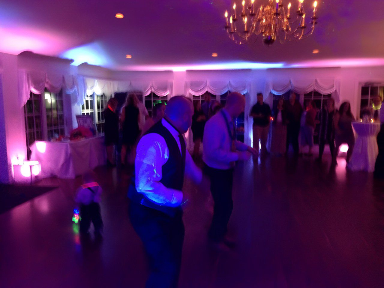 Two Men Dancing Joyfully on the Dance Floor at a Wedding Reception.
